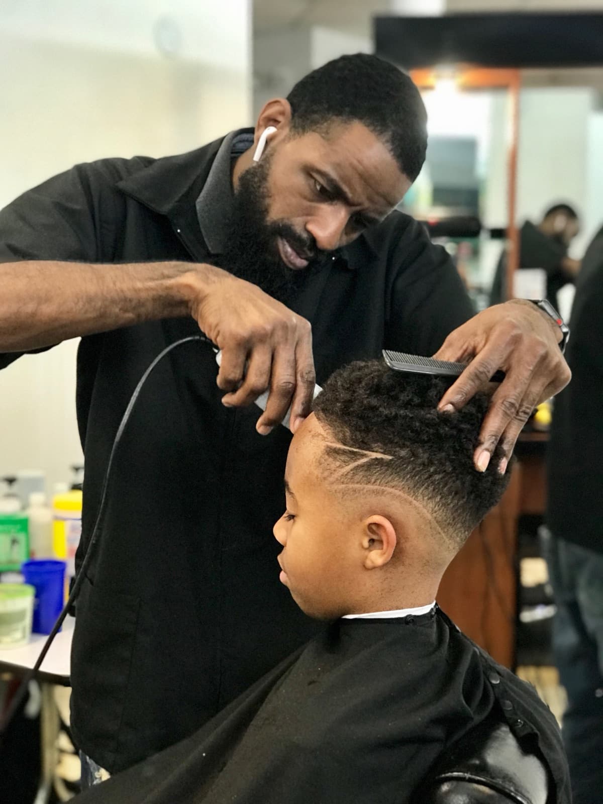 Garland Ingram, master barber and owner of Garland Cuts, cutting a client's hair in his private suite in Suwanee, GA